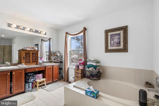 a bathroom with a tub sink and a mirror