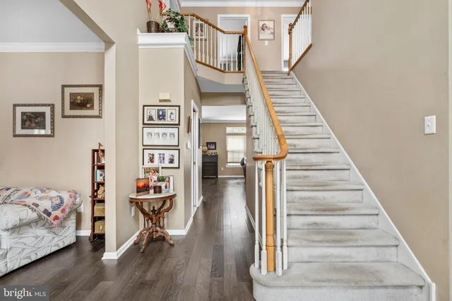 a view of entryway and hall with wooden floor