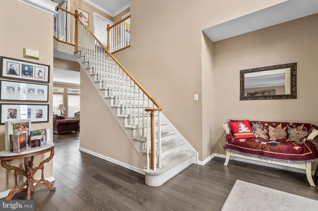 a living room with furniture and stairs