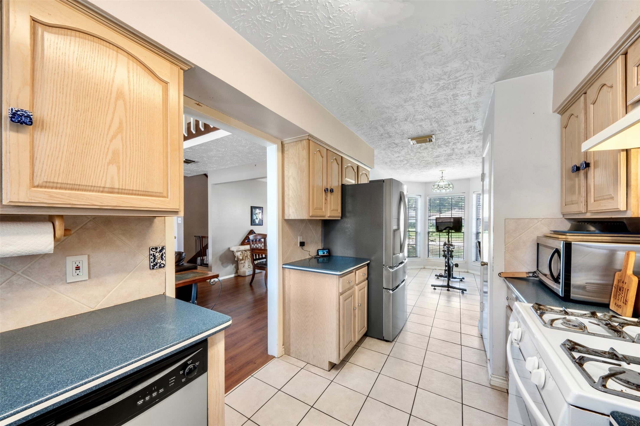 17314 Edenbridge Court Spring, TX 77379 - Photo 13 of 33 a kitchen with stainless steel appliances a stove a sink and a refrigerator