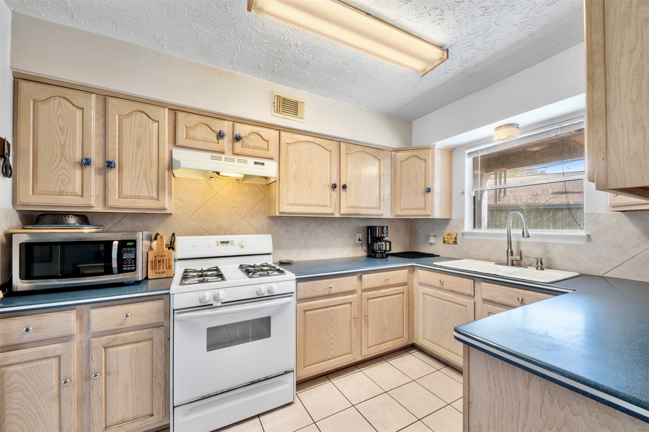17314 Edenbridge Court Spring, TX 77379 - Photo 14 of 33 a kitchen with cabinets stainless steel appliances and a window