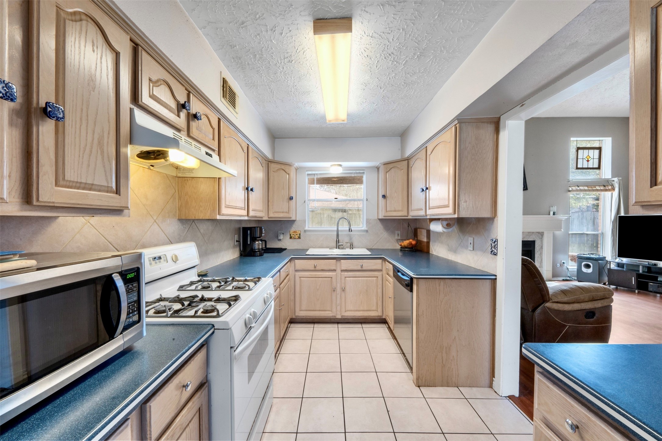 17314 Edenbridge Court Spring, TX 77379 - Photo 15 of 33 a kitchen with stainless steel appliances granite countertop a stove and a sink