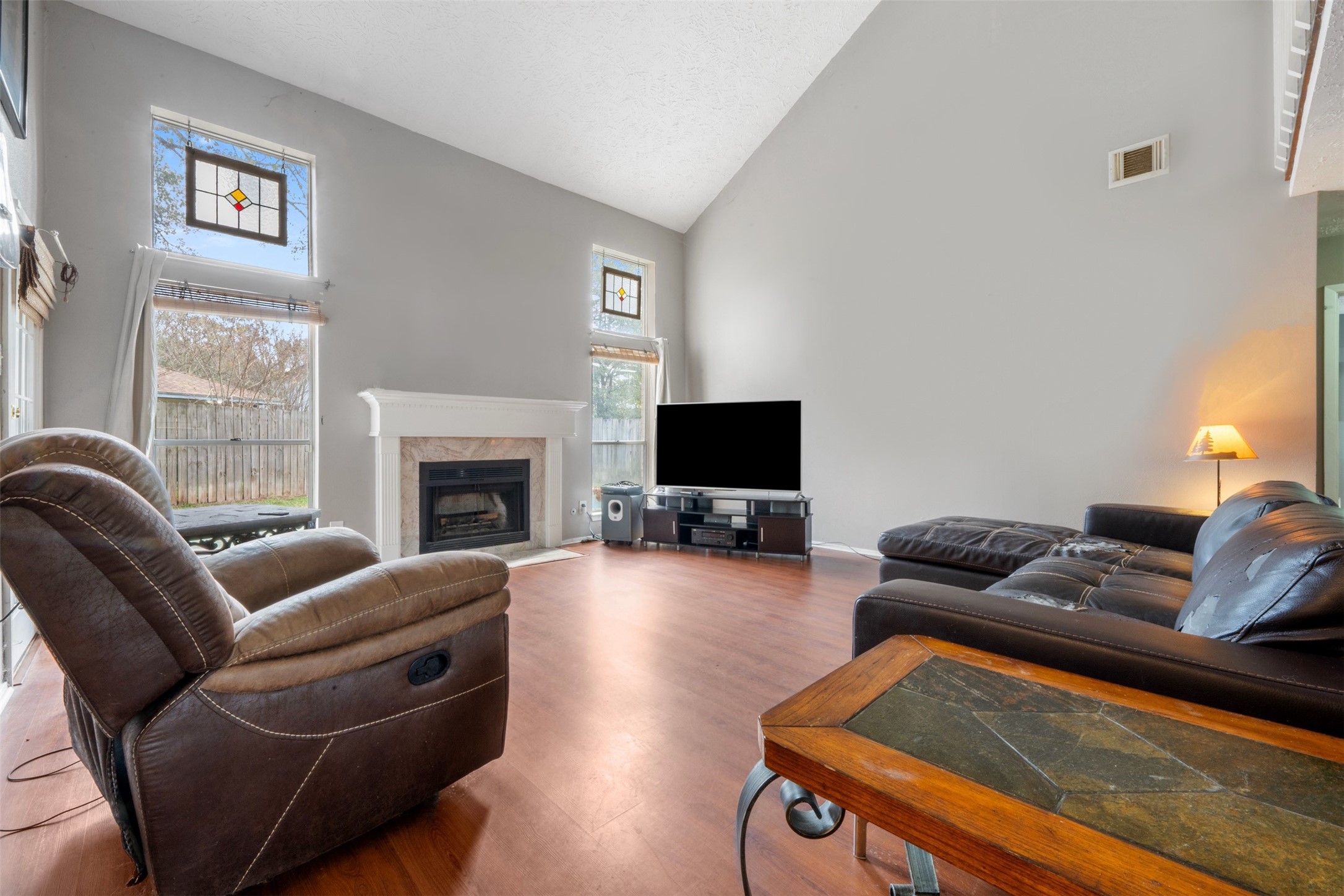 17314 Edenbridge Court Spring, TX 77379 - Photo 17 of 33 a living room with furniture a flat screen tv and a fireplace