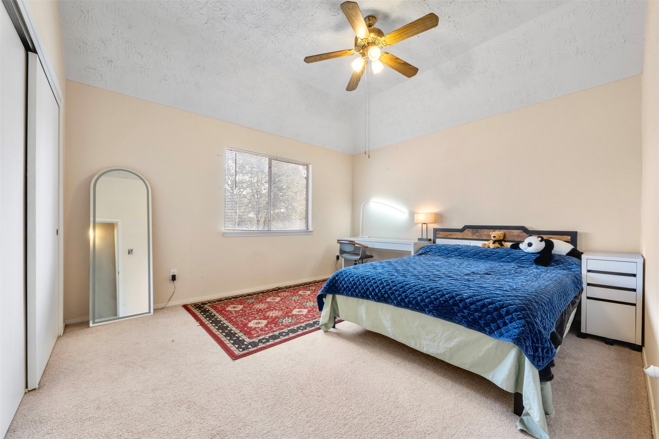 17314 Edenbridge Court Spring, TX 77379 - Photo 22 of 33 a bedroom with a bed lamp and a chandelier