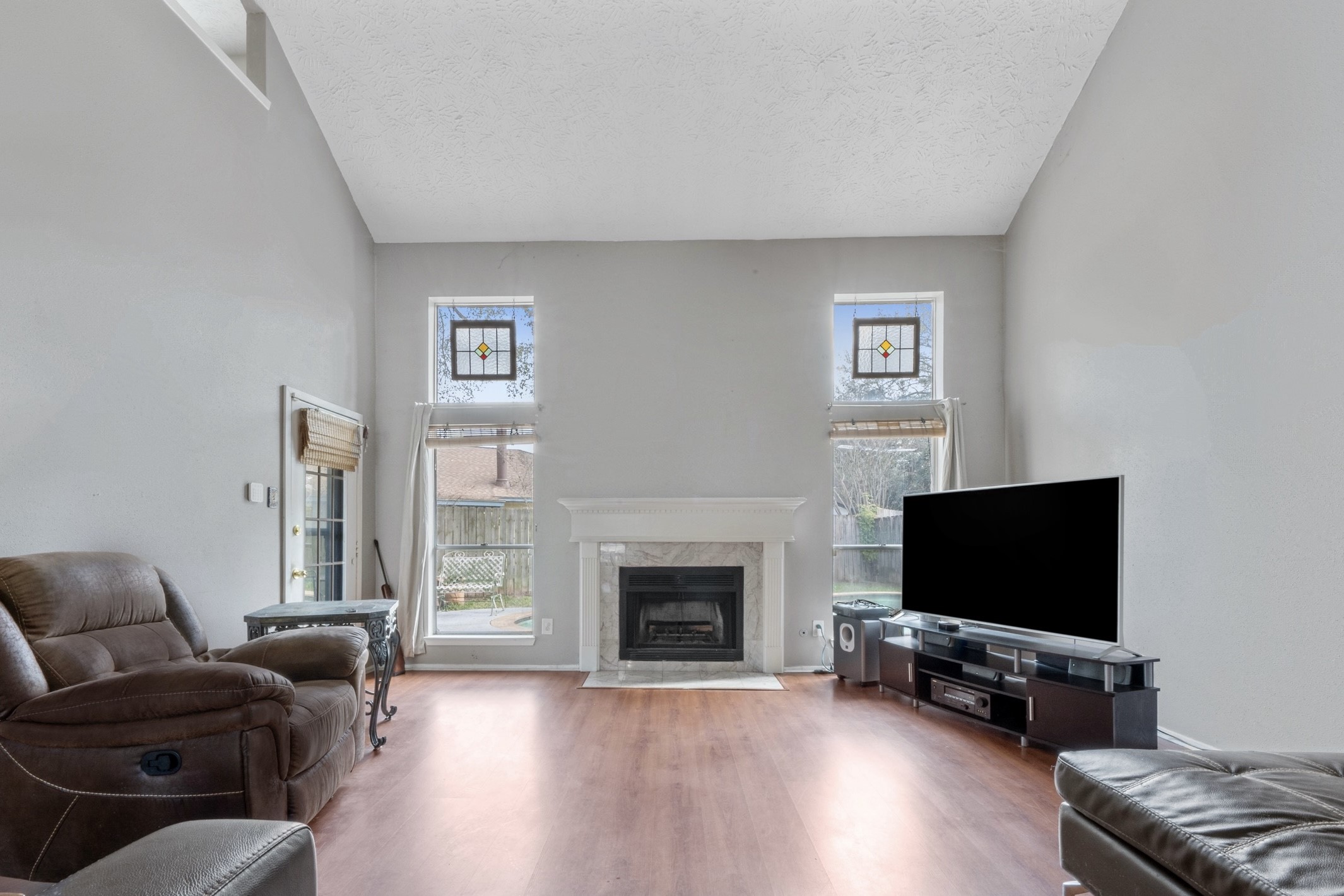 17314 Edenbridge Court Spring, TX 77379 - Photo 9 of 33 a living room with furniture a flat screen tv and a fireplace