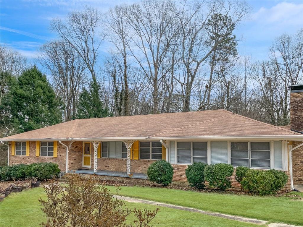 5467 Walker Road Stone Mountain, GA 30088 - Photo 1 of 1 a front view of a house with garden