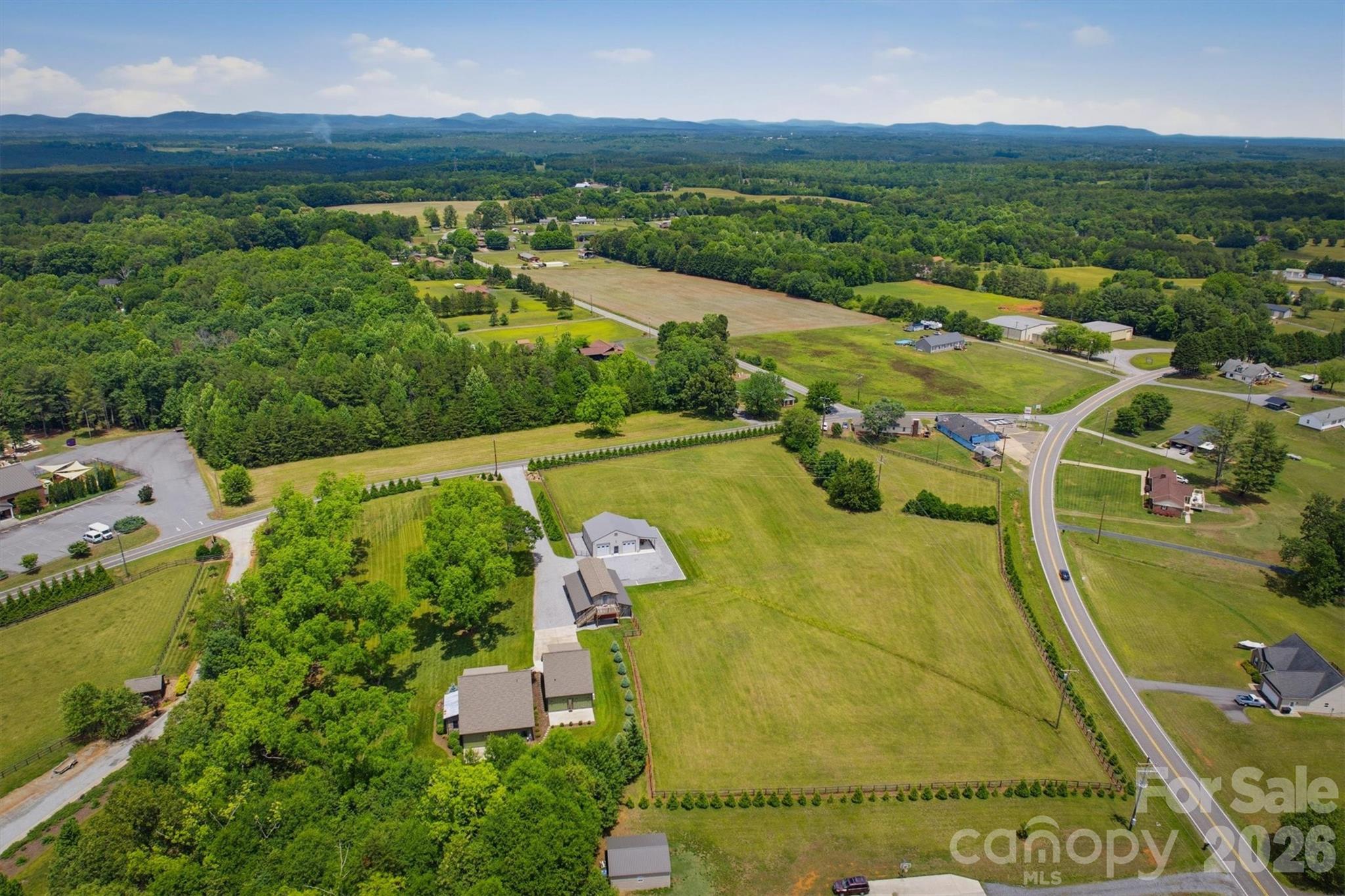 7490 Oak Ridge Church Road Connelly Springs, NC 28612 - Photo 3 of 44 an aerial view of a house with a garden