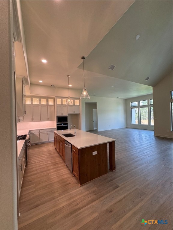 5903 Whippoorwill Road Temple, TX 76502 - Photo 7 of 27 a large kitchen with stainless steel appliances granite countertop a large counter top and a wooden floors