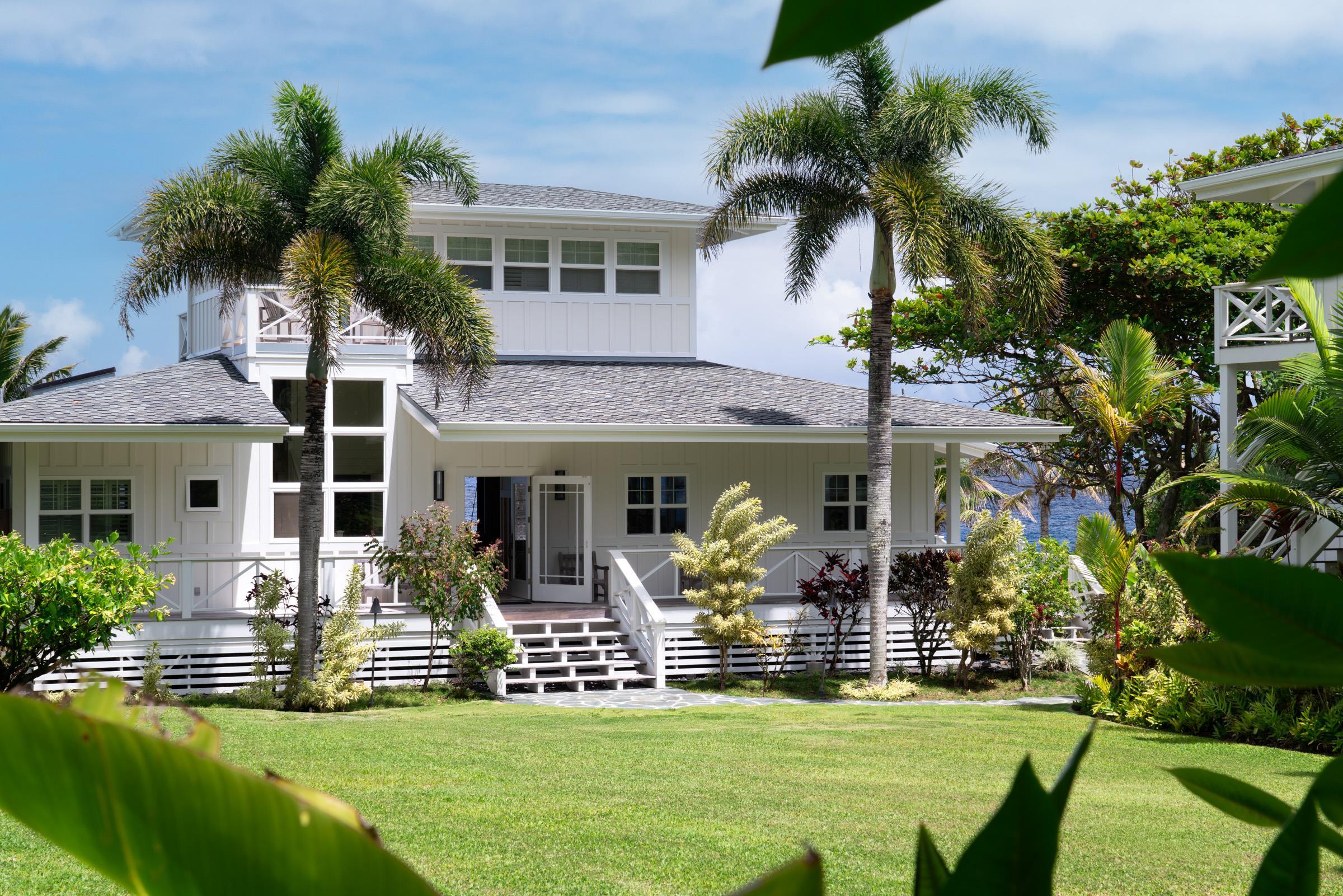 a front view of house with yard and green space