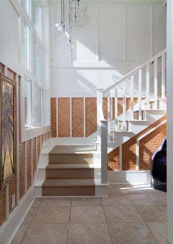 a view of a big house with a big yard and large trees
