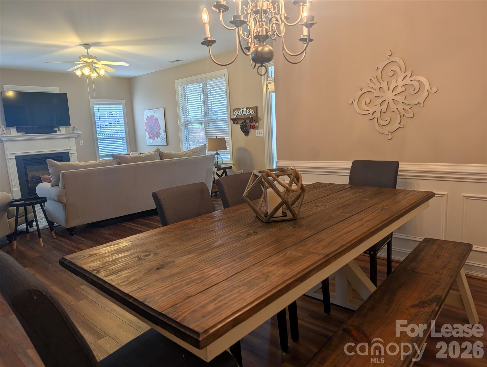 20207 Colony Point Lane Cornelius, NC 28031 - Photo 8 of 26 a view of a dining room with furniture a chandelier and wooden floor