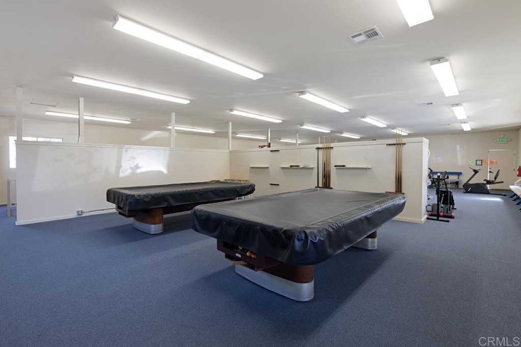 3909 Reche Road, Unit 195 Fallbrook, CA 92028 - Photo 20 of 25 a room with pool table gym equipment mirrors and a ceiling fan