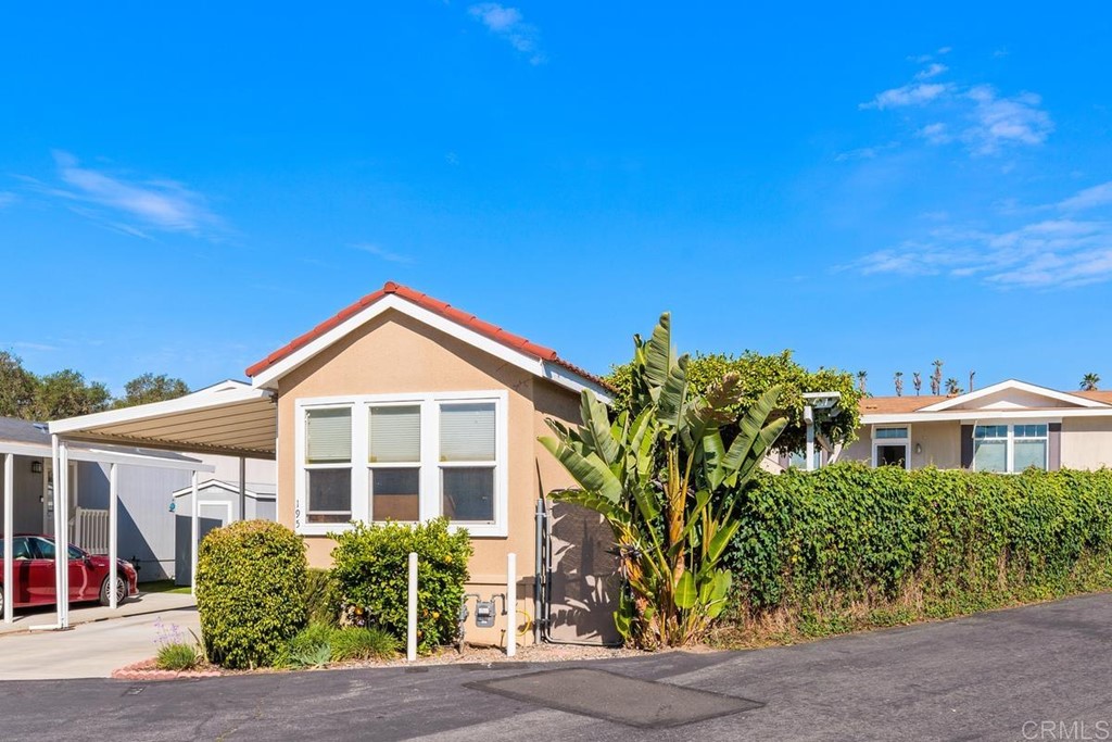3909 Reche Road, Unit 195 Fallbrook, CA 92028 - Photo 2 of 25 a front view of a house with a yard