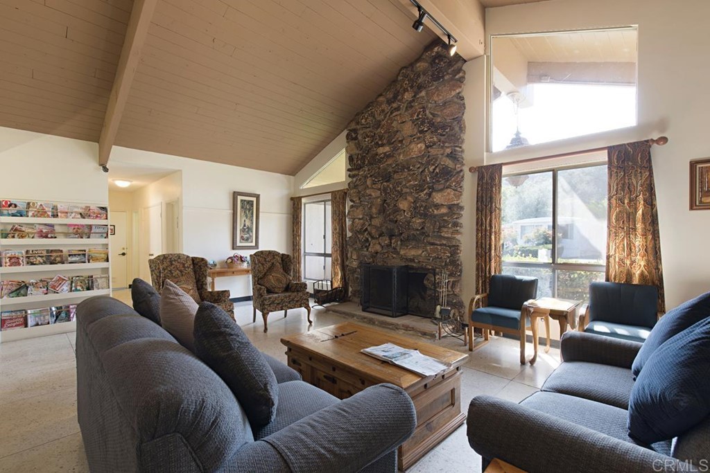 3909 Reche Road, Unit 195 Fallbrook, CA 92028 - Photo 22 of 25 a living room with furniture fireplace and a large window