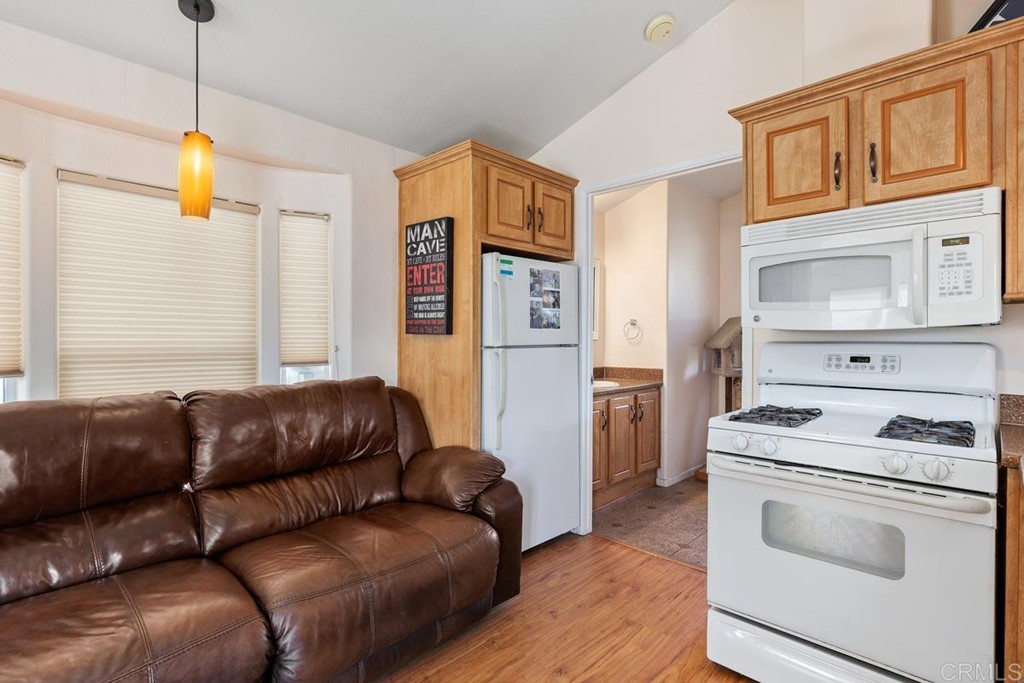 3909 Reche Road, Unit 195 Fallbrook, CA 92028 - Photo 8 of 25 a living room with a couch and a stove top oven