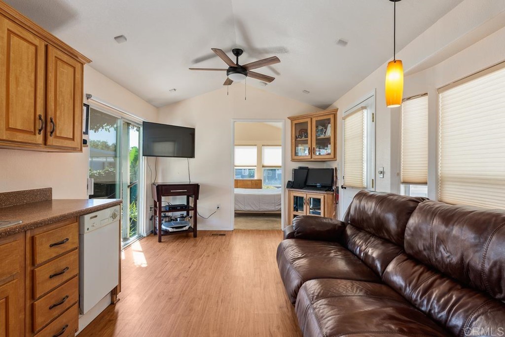 3909 Reche Road, Unit 195 Fallbrook, CA 92028 - Photo 9 of 25 a living room with furniture a fireplace and a flat screen tv