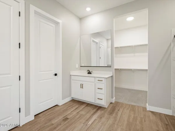 a room view with wooden floor and mirror