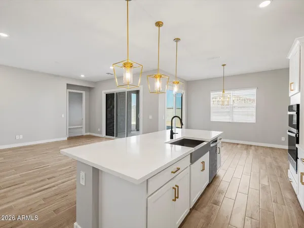 a kitchen with granite countertop a sink and chandelier