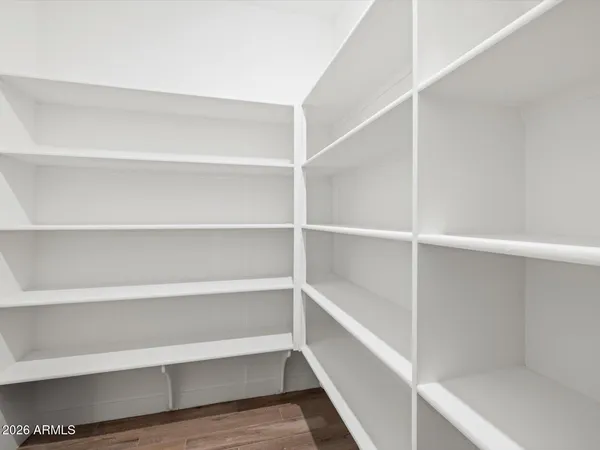 a view of walk in closet with empty racks