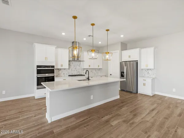 a kitchen with stainless steel appliances kitchen island a sink and a refrigerator