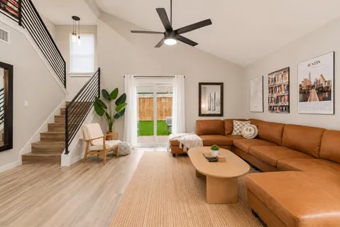 a living room with furniture and wooden floor