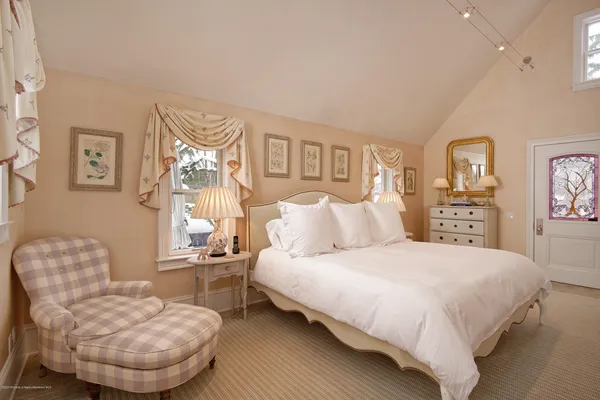 a bedroom with a bed and a chair
