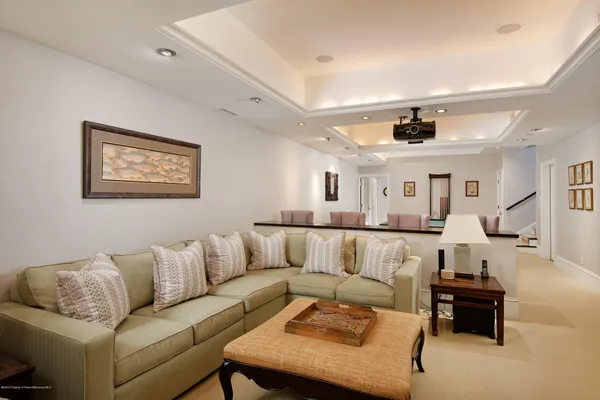 a living room with furniture and view of kitchen