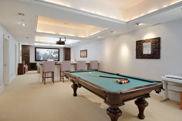 a room with furniture pool table and windows