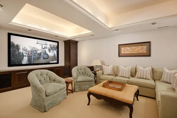 a living room with furniture a couch and painting on wall