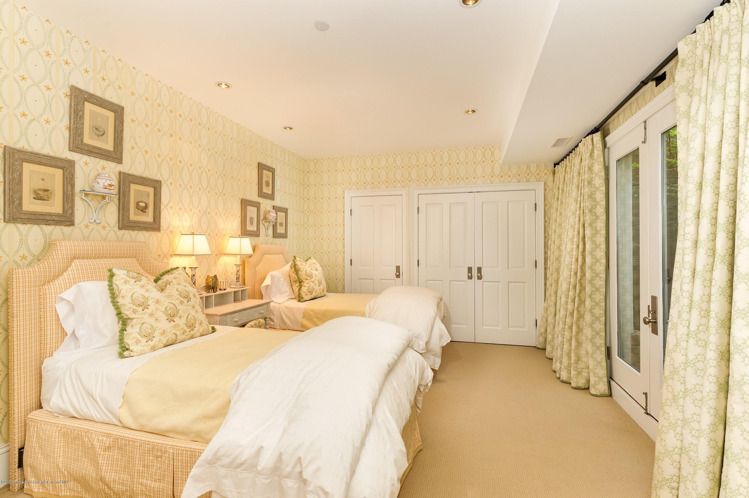 716 West Francis Street Aspen, CO 81611 - Photo 17 of 26 a spacious bedroom with a bed and a window