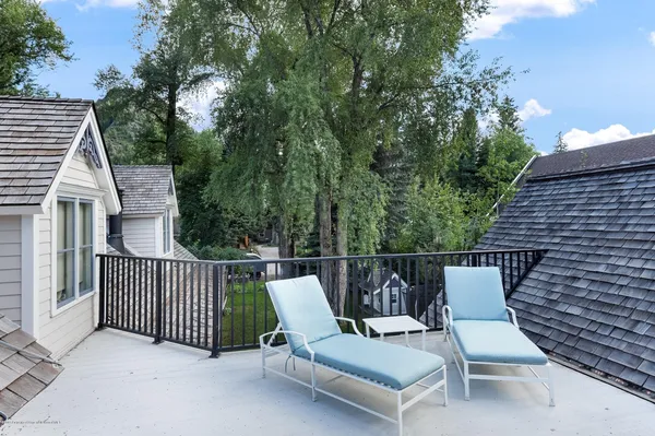 a view of a chair and table in the balcony