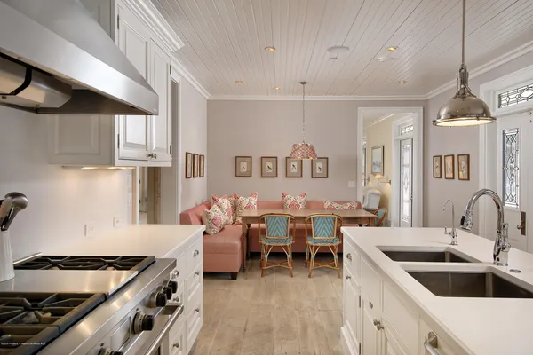 a kitchen with a stove and a white cabinets
