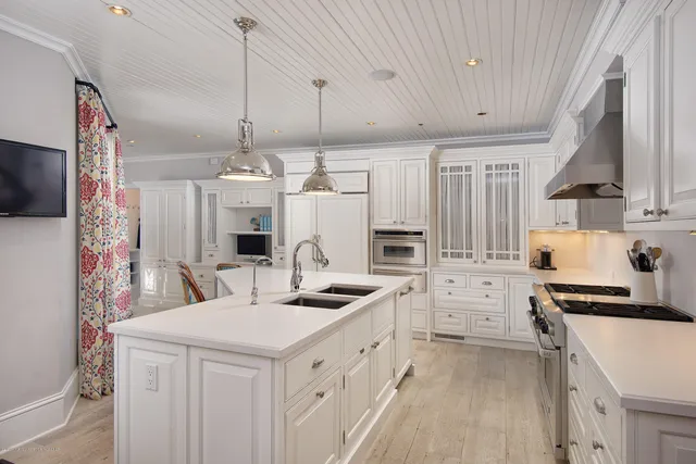 a kitchen with stainless steel appliances kitchen island granite countertop a sink and cabinets
