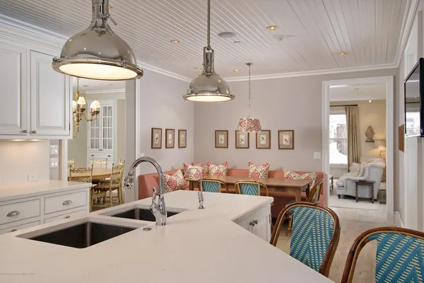 a kitchen with stainless steel appliances a table and chairs