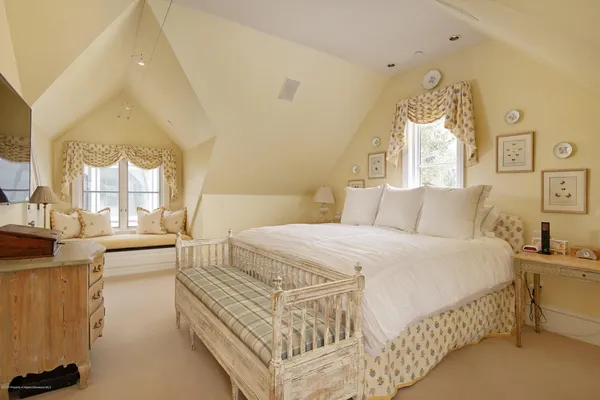 a bed room with a bed and a chandelier