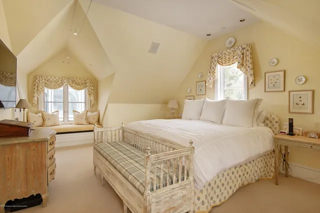 a bed room with a bed and a chandelier