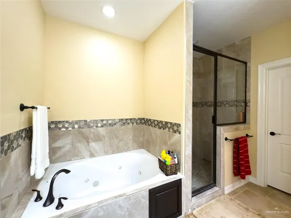 a bathroom with a bathtub and a shower