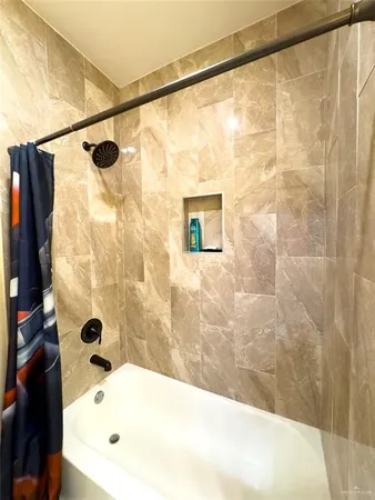 a bathroom with a bathtub and shower
