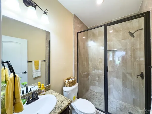 a bathroom with a sink toilet and shower