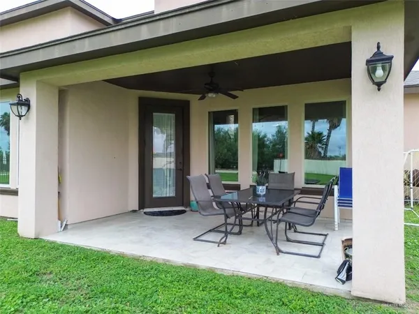 a building outdoor space with couple of furniture and garden