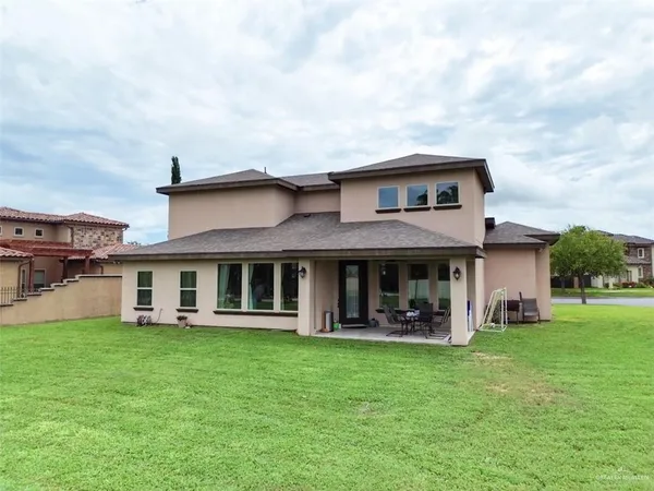 a view of a house with a yard and sitting area