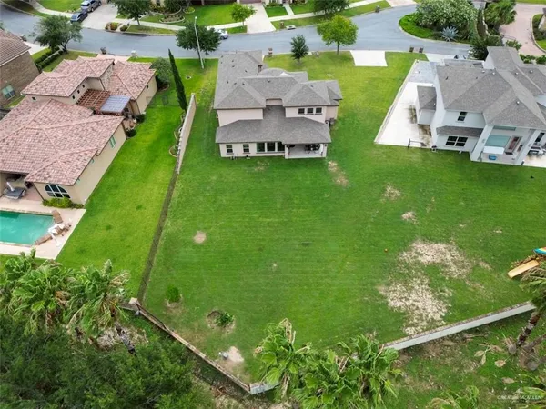 an aerial view of residential houses with outdoor space and street view