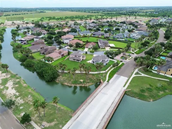 an aerial view of lake residential houses with outdoor space and swimming pool