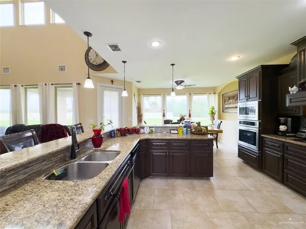 a large kitchen with a large counter top appliances and cabinets