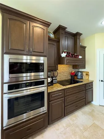 a kitchen with wooden cabinets and stainless steel appliances