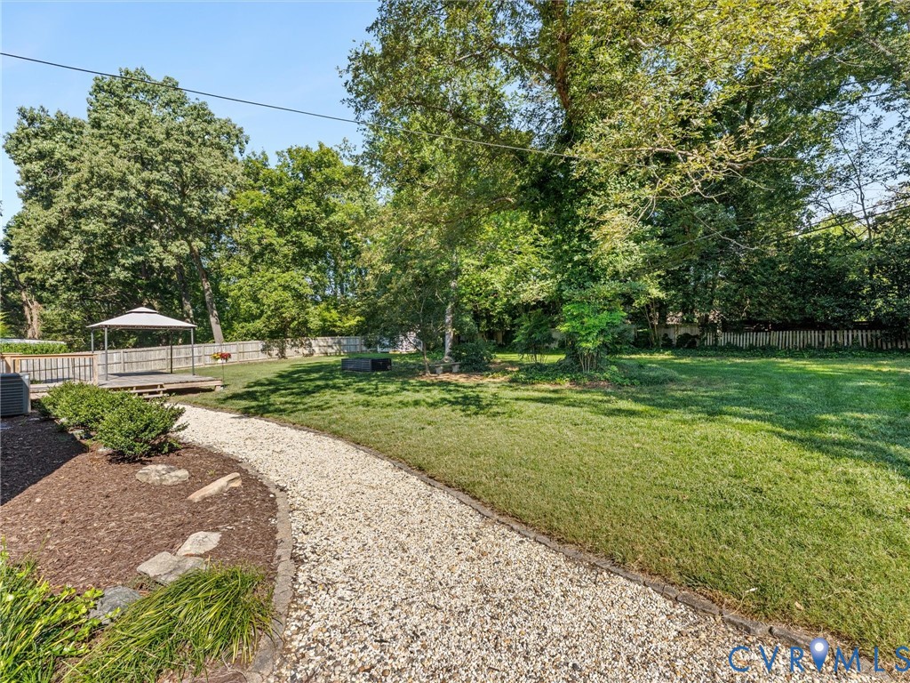 7720 Prairie Road Richmond, VA 23225 - Photo 35 of 49 Expansive backyard featuring a gravel path, a spac