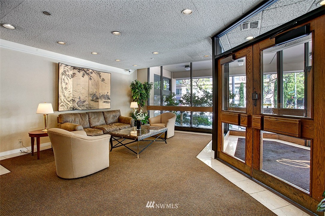2201 3rd Avenue, Unit 1001 Seattle, WA 98121 - Photo 14 of 20 a living room with furniture and a floor to ceiling window