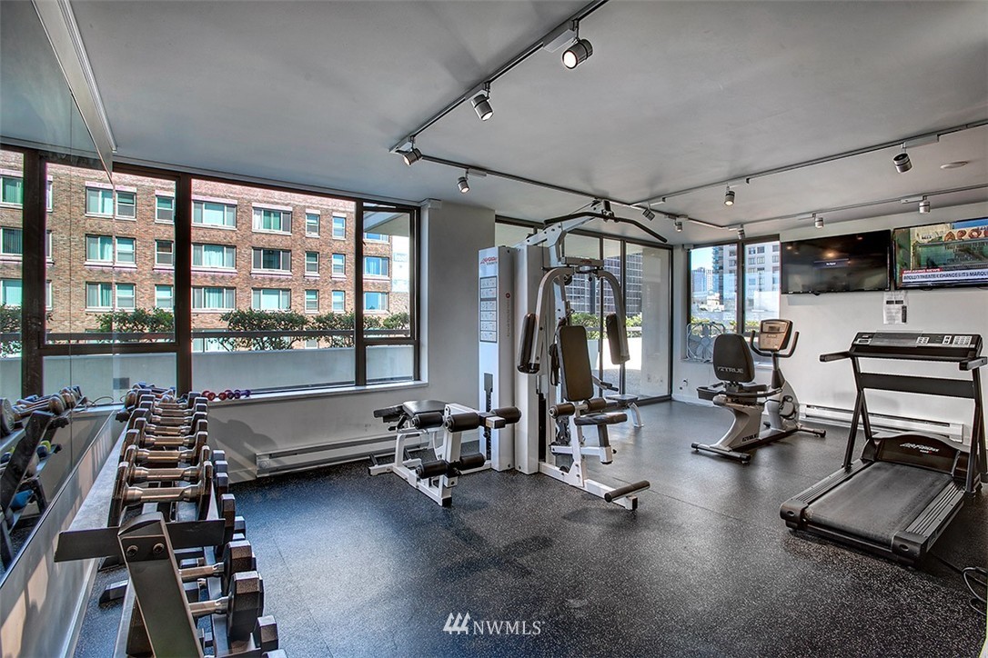 2201 3rd Avenue, Unit 1001 Seattle, WA 98121 - Photo 16 of 20 a room with gym equipment and floor to ceiling window