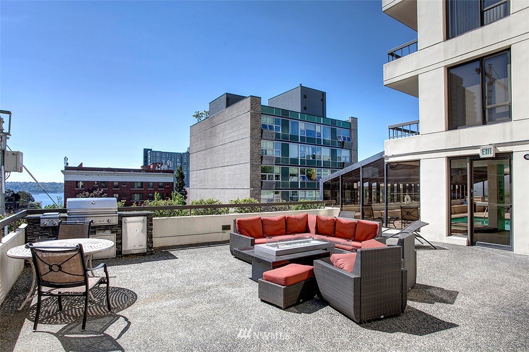 2201 3rd Avenue, Unit 1001 Seattle, WA 98121 - Photo 17 of 20 a outdoor sitting area with a couch and chairs