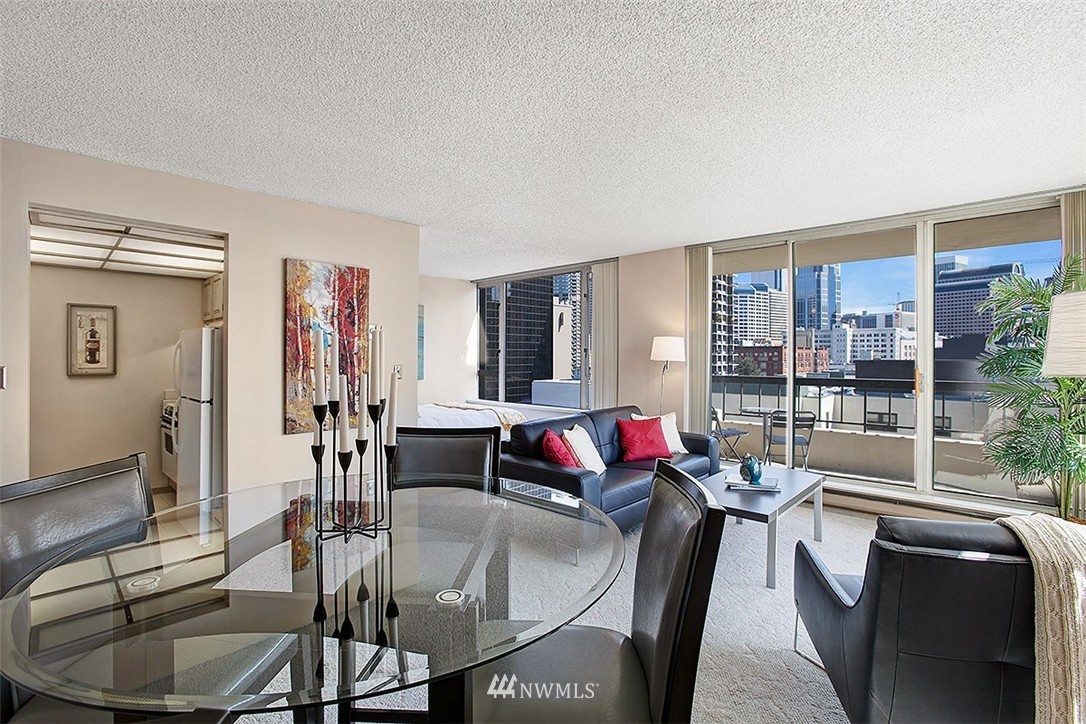 2201 3rd Avenue, Unit 1001 Seattle, WA 98121 - Photo 4 of 20 a living room with furniture and a floor to ceiling window